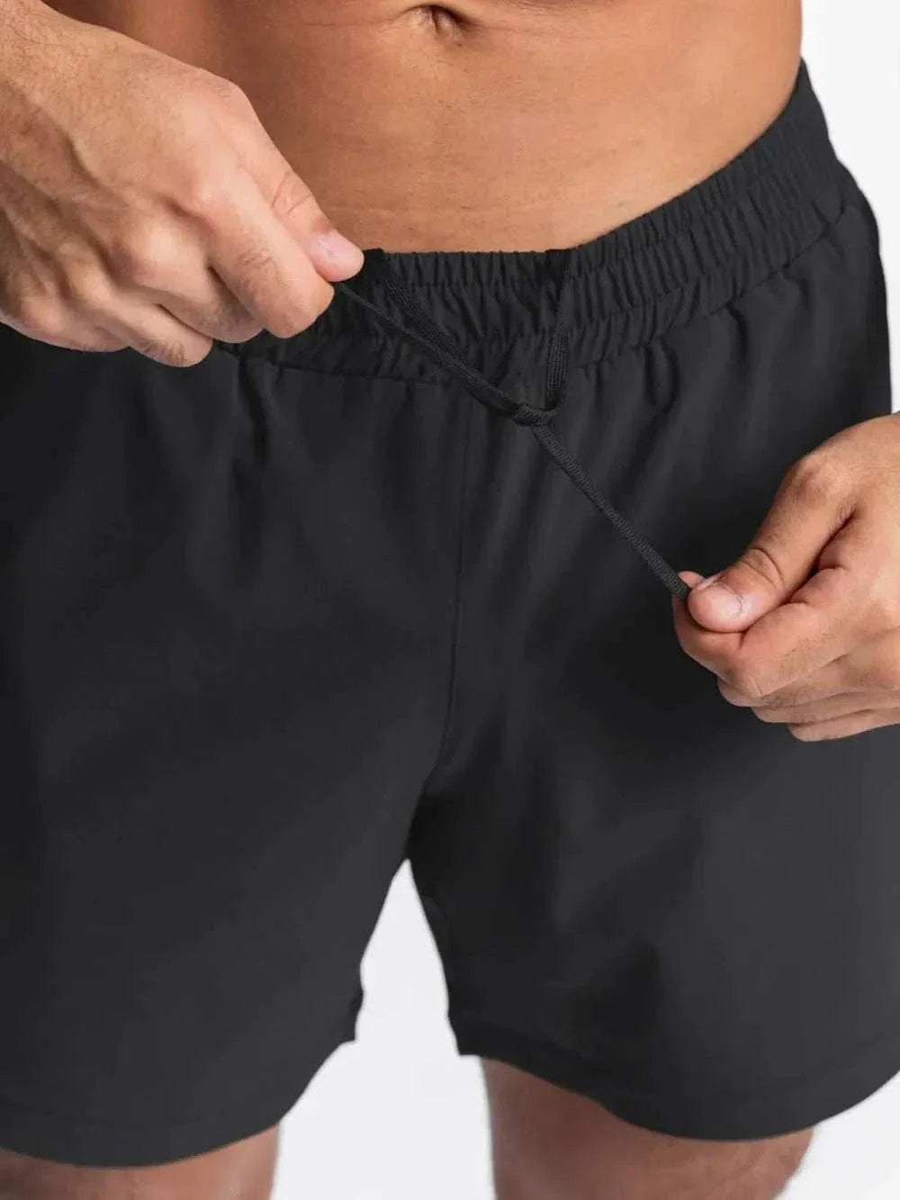 Men's black elastic waist active shorts for workouts and sports.