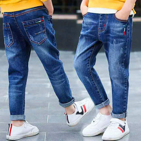 Boys denim jeans with rolled cuffs and colorful stitching, showcasing a trendy style and comfortable fit.