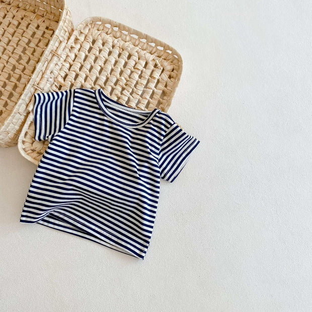 Striped T-shirt from Two-Piece Baby Suit laid on a woven basket.