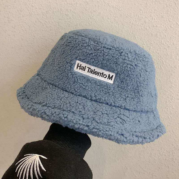 Lambswool Female Fishing Cap in blue with short brim and embroidered text.
