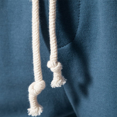 Close-up of blue Tether Shorts for Men with white drawstring detail.