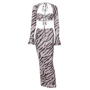 Zebra stripe printed long-sleeve slim skirt suit with matching top and flared sleeves.