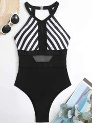 Black and white striped mesh backless one-piece swimsuit with halter neck and cutout detail.