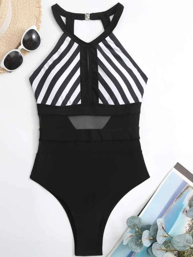 Black and white striped mesh backless one-piece swimsuit with halter neck and cutout detail.