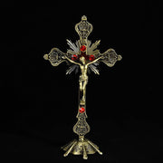 Religious Cross Ornament with intricate gold design and red accents.