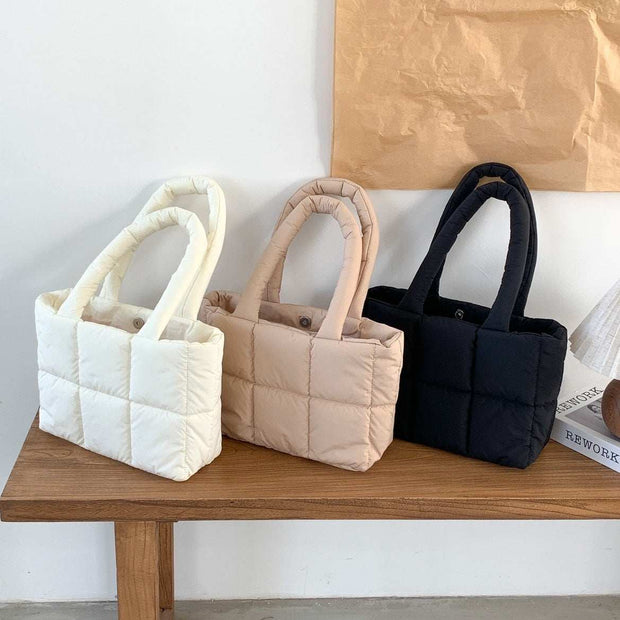 Large Capacity Hand Bag in cream, apricot, and black on wooden table.