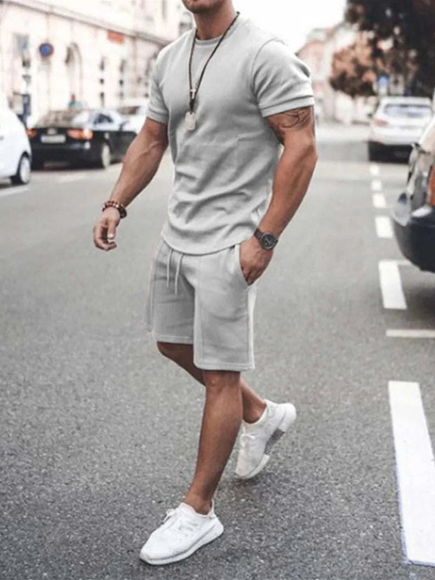 Plus size short sleeve top and shorts set in gray, featuring a classic crew neckline and elastic waistband, ideal for casual wear.