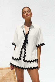 Stylish 2 Piece Summer Suit with black trim, perfect for warm weather.