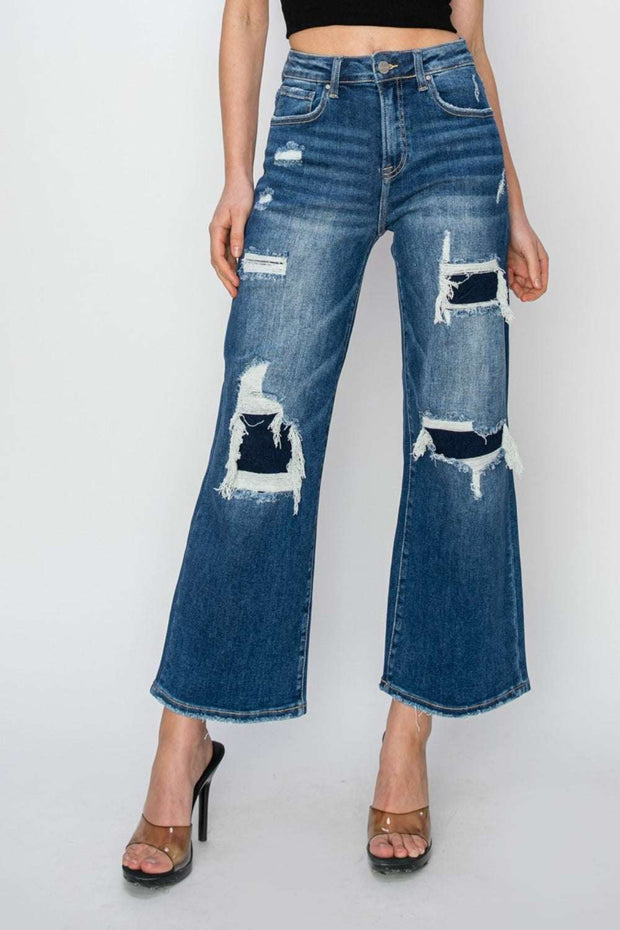Risen Wide Leg Crop Jeans with high-rise fit and patch detailing, worn with heels.