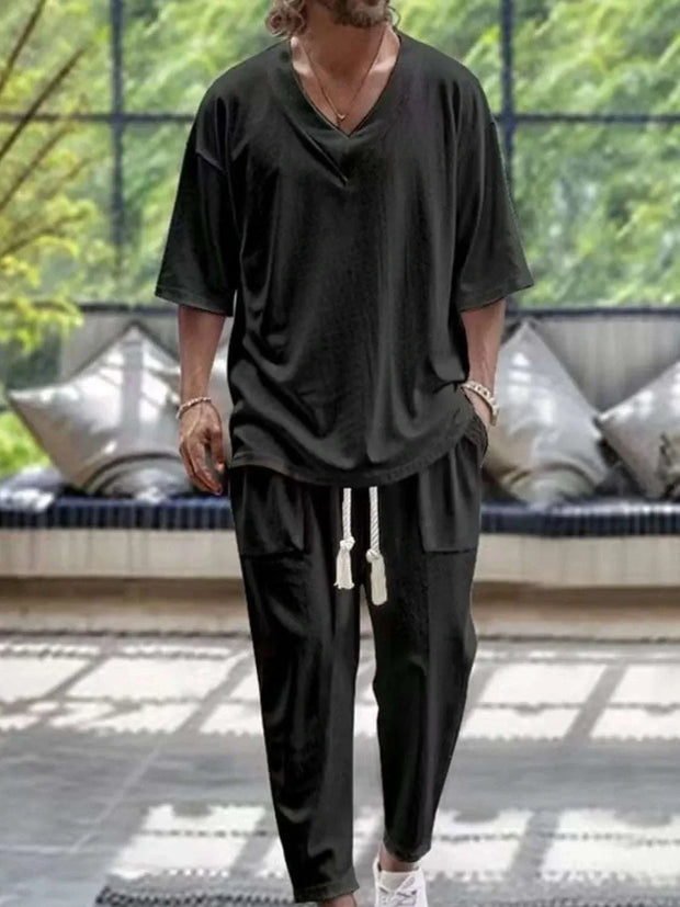 Men's V-Neck Half Sleeve Top and Pants Set in black, casual fit, indoors.