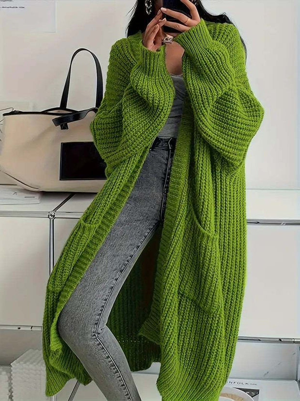 Green long sleeve long knitted cardigan worn with gray jeans and white top