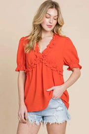 Lime N Chili Ruffled Puff Sleeve Babydoll Top in vibrant orange with deep V-neckline and ruffled details.
