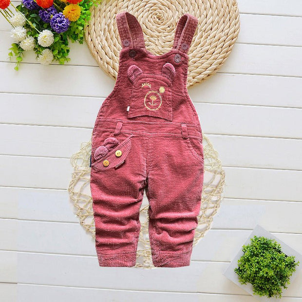 Children overalls with cartoon pattern, adjustable straps, and pockets for winter wear.