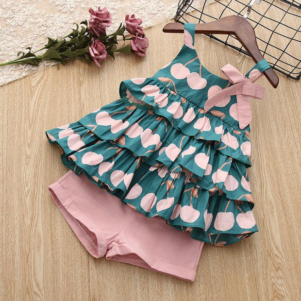 Cake skirt camisole set with playful design and matching shorts on a hanger with roses.