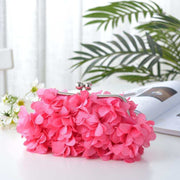 Elegant pink bridal clutch with floral detailing, perfect for weddings.