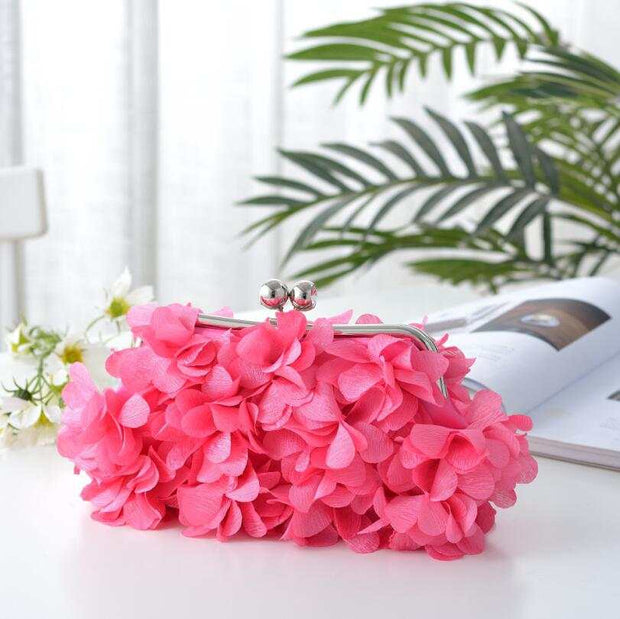 Elegant pink bridal clutch with floral detailing, perfect for weddings.