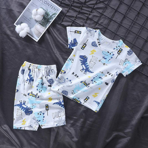 Youth pajama set with playful dinosaur pattern on soft fabric, short-sleeve top, and matching shorts.