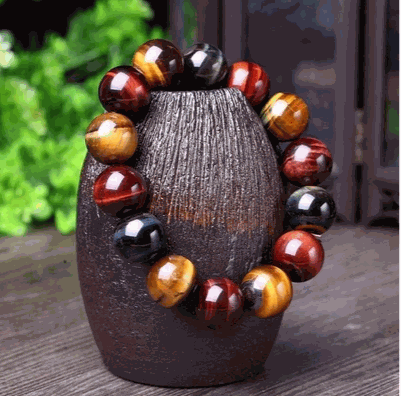 Tiger Eye Bracelet with natural crystal stones and polished beads on display.