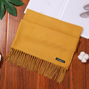Luxurious designer scarf shawl in mustard yellow with fringe detailing.