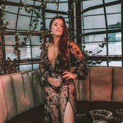Elegant woman wearing a Hot Lace Dress Europe-America with intricate lace detailing, sitting in a stylish venue.