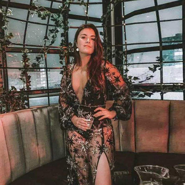 Elegant woman wearing a Hot Lace Dress Europe-America with intricate lace detailing, sitting in a stylish venue.
