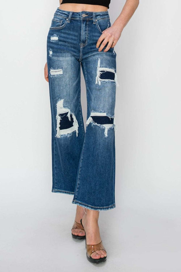 Wide-leg crop jeans with distressed patches, high-rise fit, and classic five-pocket styling.