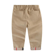 Boys casual cotton trousers with elastic waistband and adjustable drawstrings in beige color.