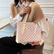 Large Capacity Handbag with monogram design in cream and beige shades.