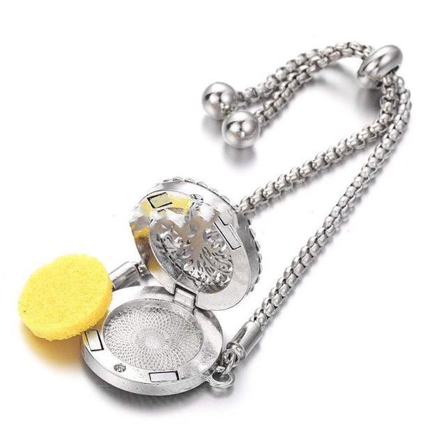 Hollow stainless steel aromatherapy bracelet with open compartment for essential oils and adjustable band.