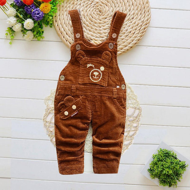 Children overalls with cartoon pattern, adjustable straps, brown color, styled for winter wear.
