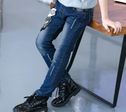 Boys wearing blue denim jeans with a skull patch, paired with black boots.