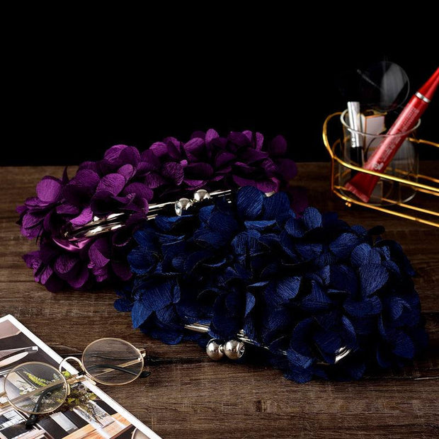 Elegant bridal clutch with floral details in purple and dark blue, ideal for weddings and special occasions.