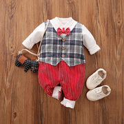 Baby Gentleman Jumpsuit with plaid vest, striped pants, and bowtie on wooden background.