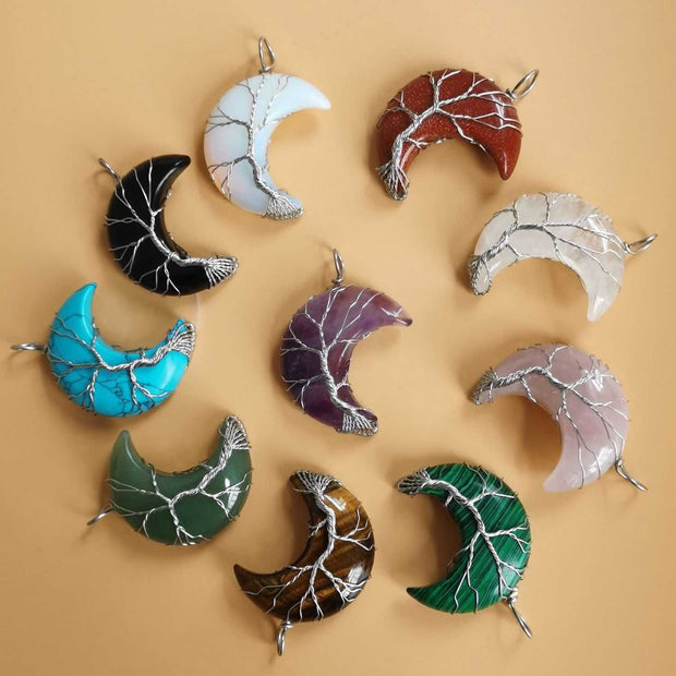 Colorful Moon Tree pendants in a crescent shape with crystal accents.