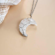 Moon Tree Of Life Necklace with crystal pendant featuring a tree design and moon accents.