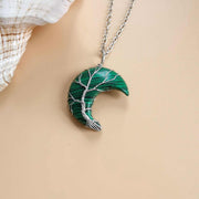 Moon Tree Of Life Necklace with celestial moon and tree design on a water wave chain.