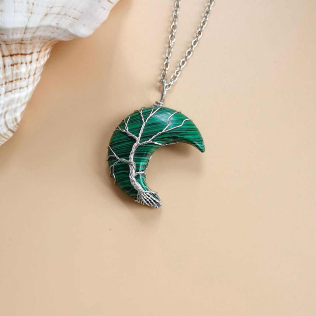Moon Tree Of Life Necklace with celestial moon and tree design on a water wave chain.