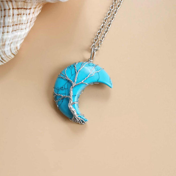 Moon Tree Of Life Necklace with a crescent pendant, featuring artistic tree design and celestial motifs.