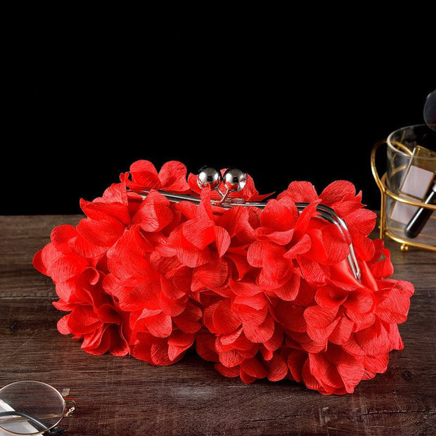 Red floral bridal clutch with silver clasp, perfect wedding accessory.