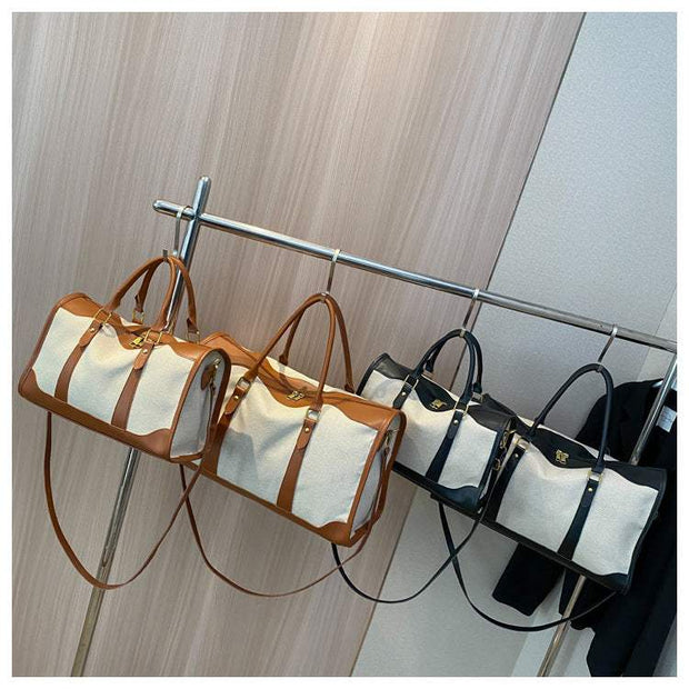 Large capacity purses in black and brown on a clothing rack.