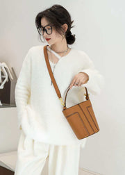 Large Capacity Shoulder Bag in brown, stylish and spacious wood-grain design, worn with white attire.