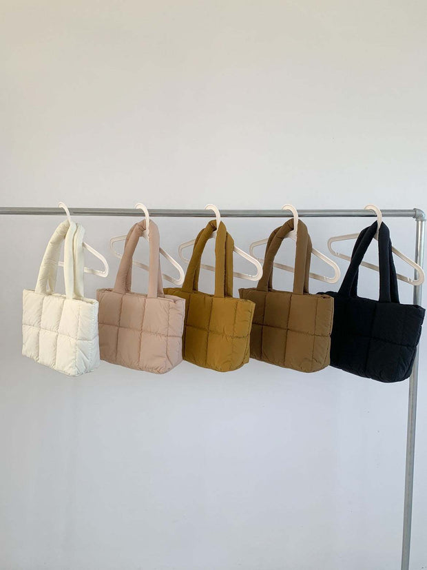 Large Capacity Hand Bag in various colors on hangers, showcasing versatility and style.