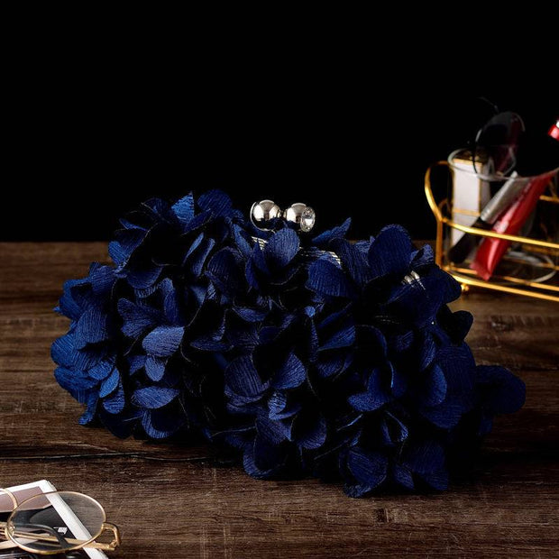 Elegant dark blue bridal clutch with floral design, perfect for weddings.