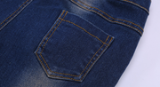 Close-up view of durable denim pocket on boys blue jeans.