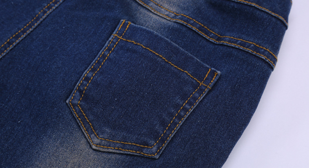 Close-up view of durable denim pocket on boys blue jeans.