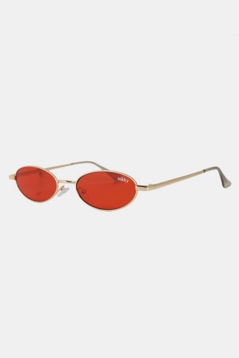Nicole Lee Finley Oval Metal Frame Sunglasses with red lenses, sleek metal arms, and UV400 protection.