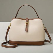 Milky white ladies messenger bag with adjustable strap and elegant design.