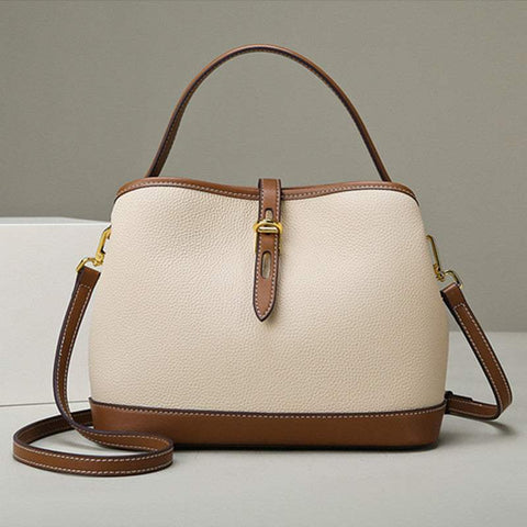 Milky white ladies messenger bag with adjustable strap and elegant design.