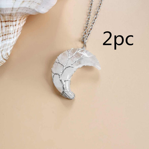 Moon Tree Of Life Necklace with crystal pendant on water wave chain, symbolizing growth and connection.