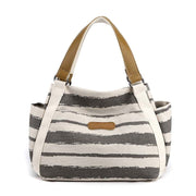 Stylish one-shoulder tote bag with spacious canvas design and elegant stripe pattern.